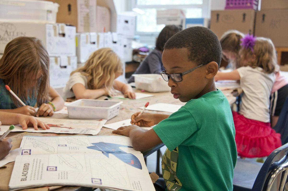 Young pupil concentrating on an activity